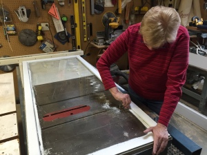 Pat removing paint from glass