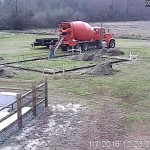 Concrete being installed in the footer trench to complete the 18-inch footer.