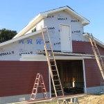 Rear of Barn, second story door in place as siding continues.